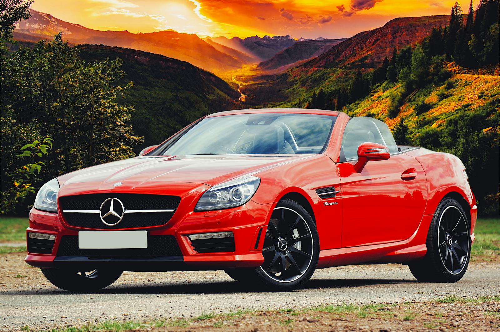 Non-Standard Auto, stunning red Mercedes Benz convertible parked against a breathtaking Scottish sunset backdrop.
